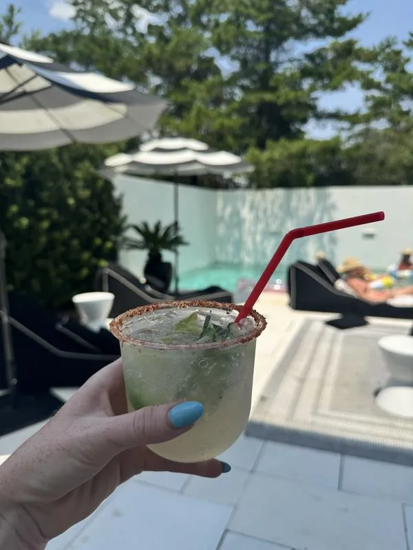 A chili-rimmed cocktail held up poolside