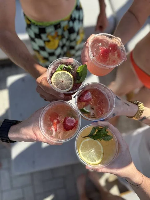 Friends clinking Happy Pour cocktails together