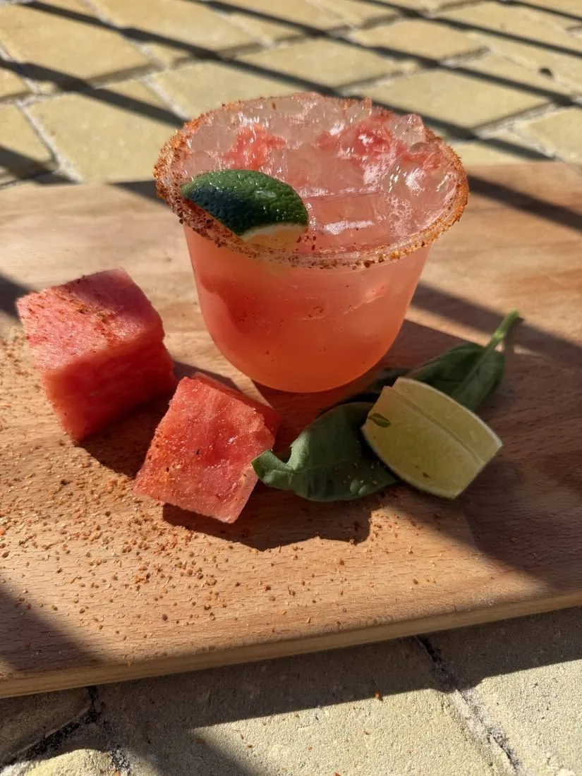A watermelon margarita with a chili-salt rim and fresh lime
